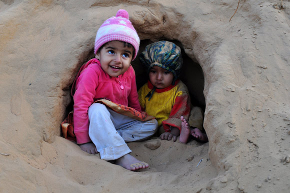 Children enjoying in sand cave